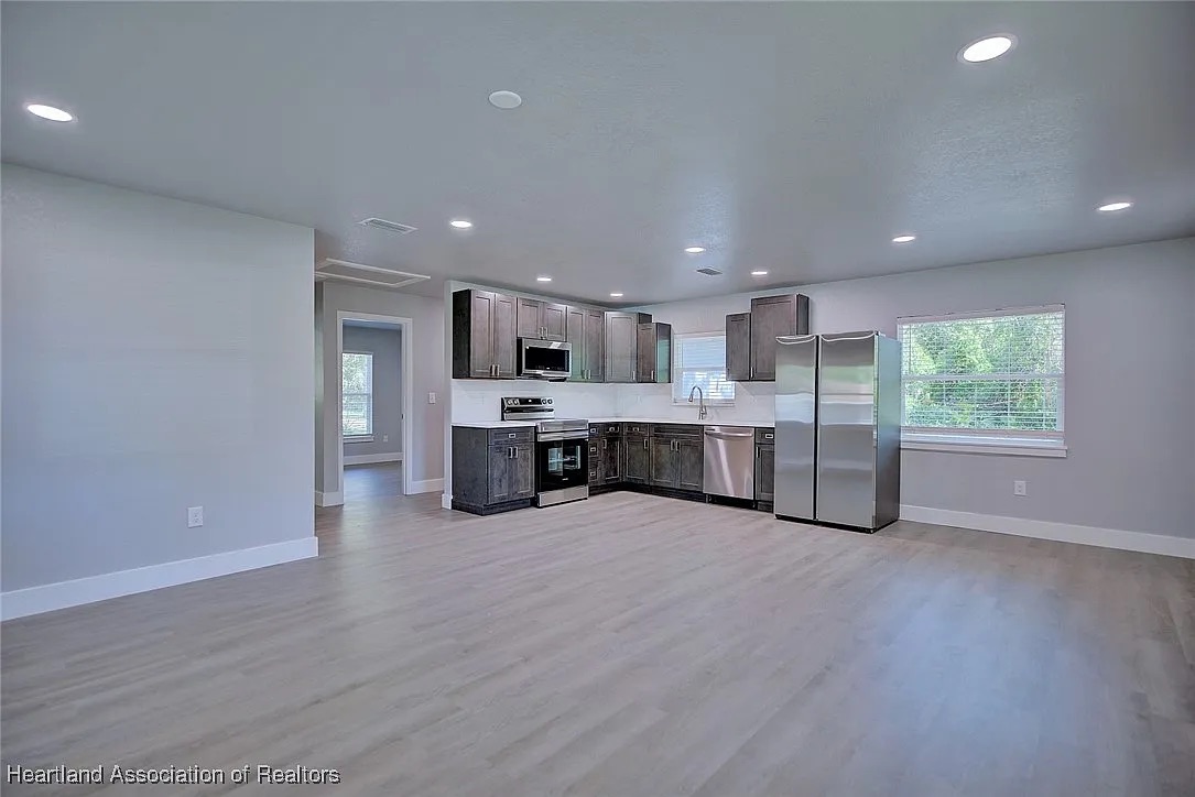 Wide view of compact gray Shaker kitchen
