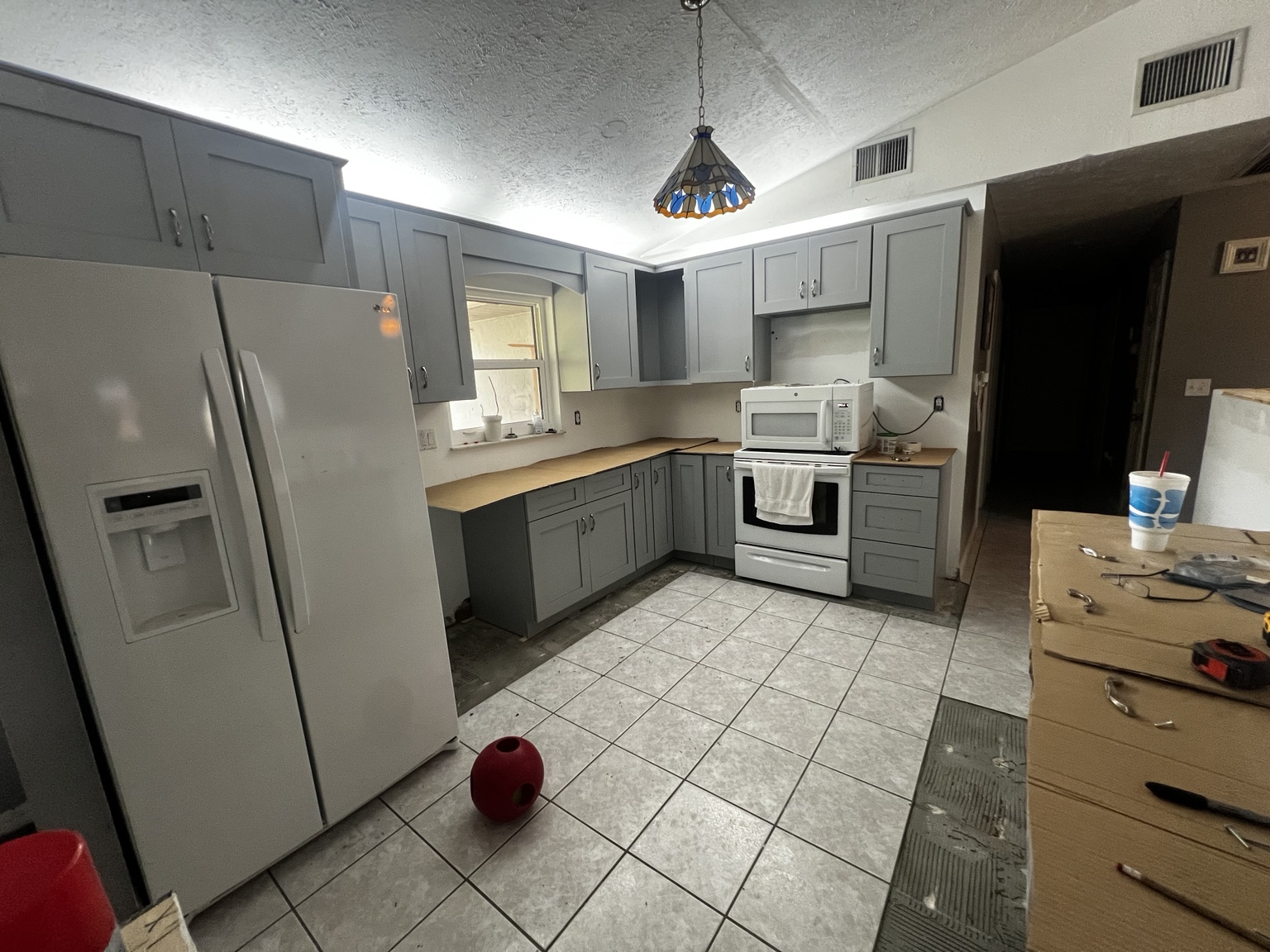 Gray Shaker cabinets installed around existing kitchen