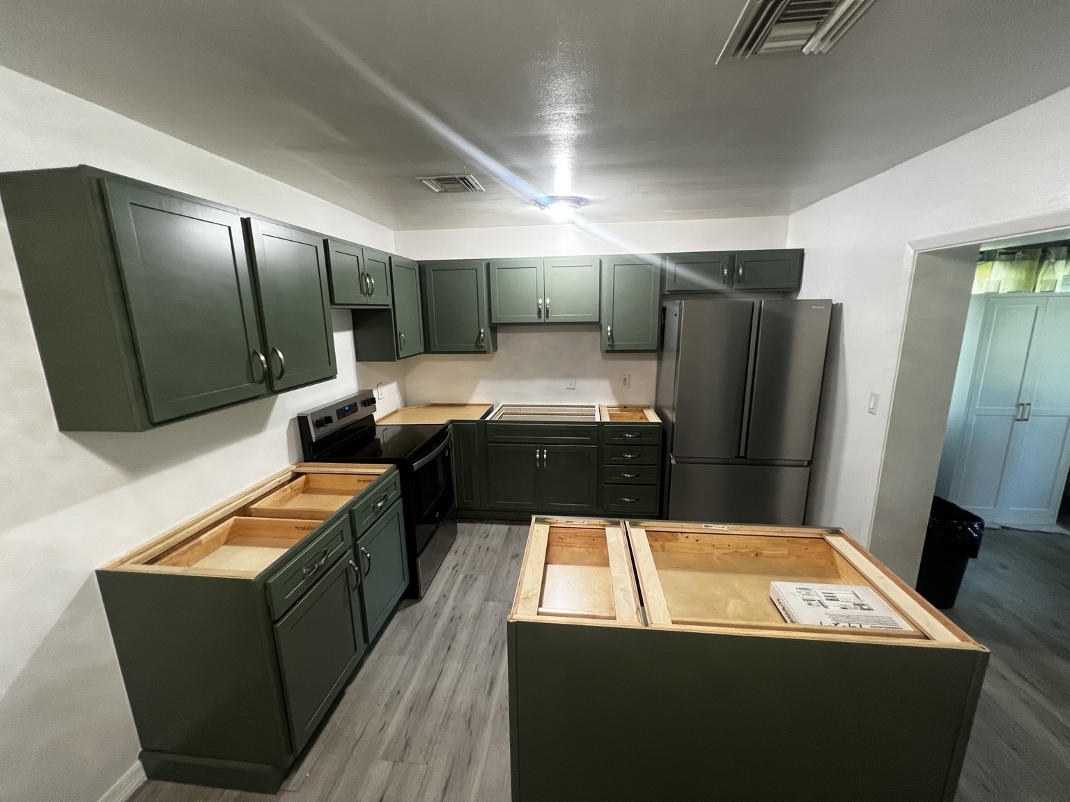 Green Shaker cabinets and island during installation